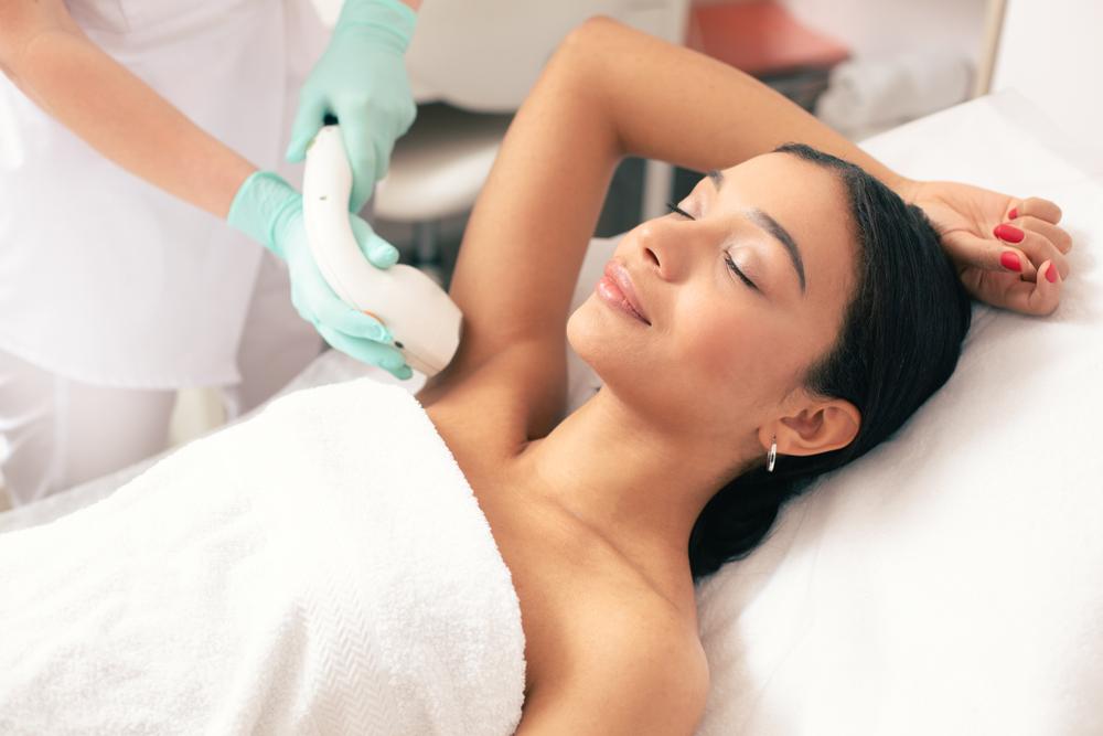 woman getting laser hair removal on her underarms